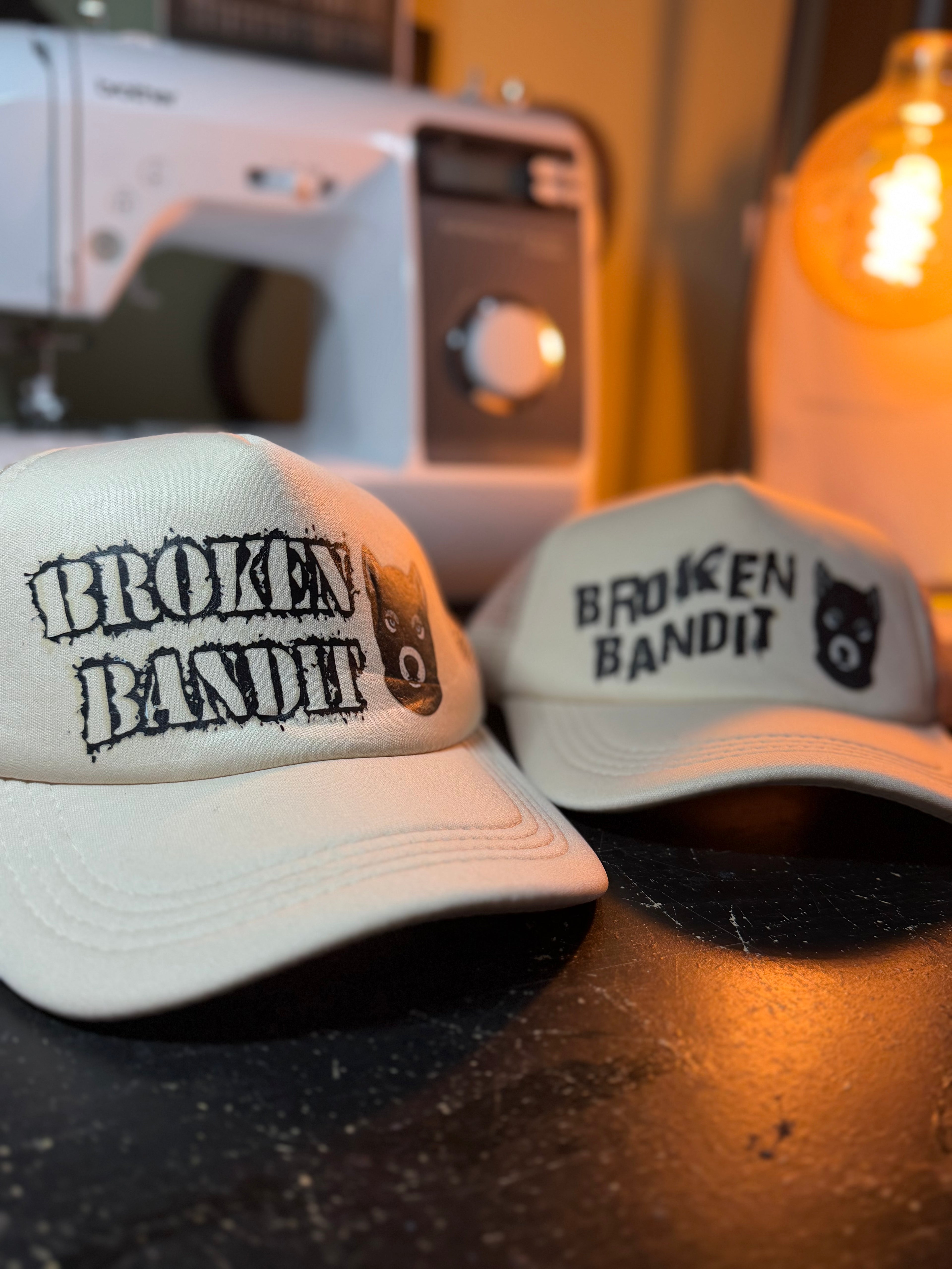 Headstrong collection of caps featuring the design 'BROKEN BANDIT', showcasing self-expression and attitude.