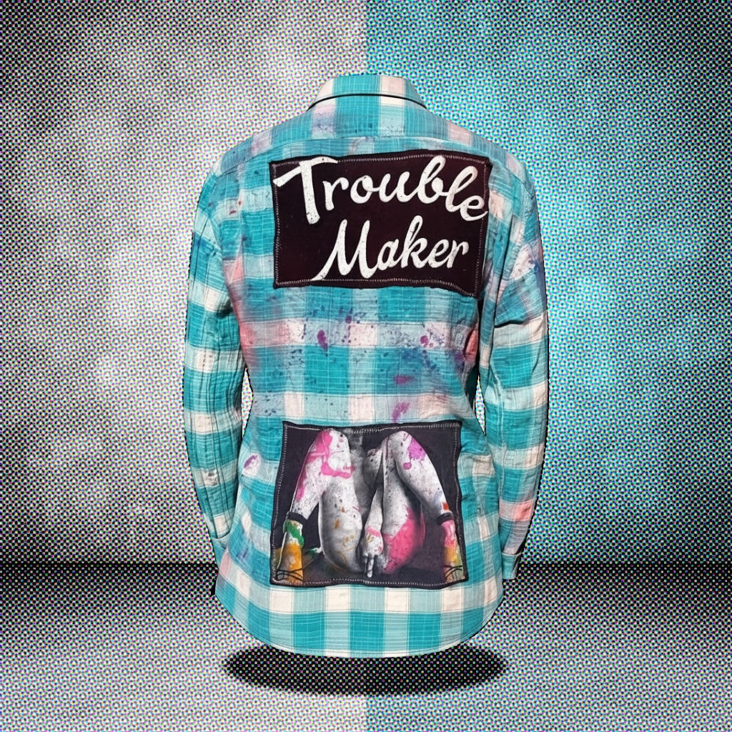 Controversial Flannels unique blue plaid shirt featuring 'Trouble Maker' design and expressive back artwork.