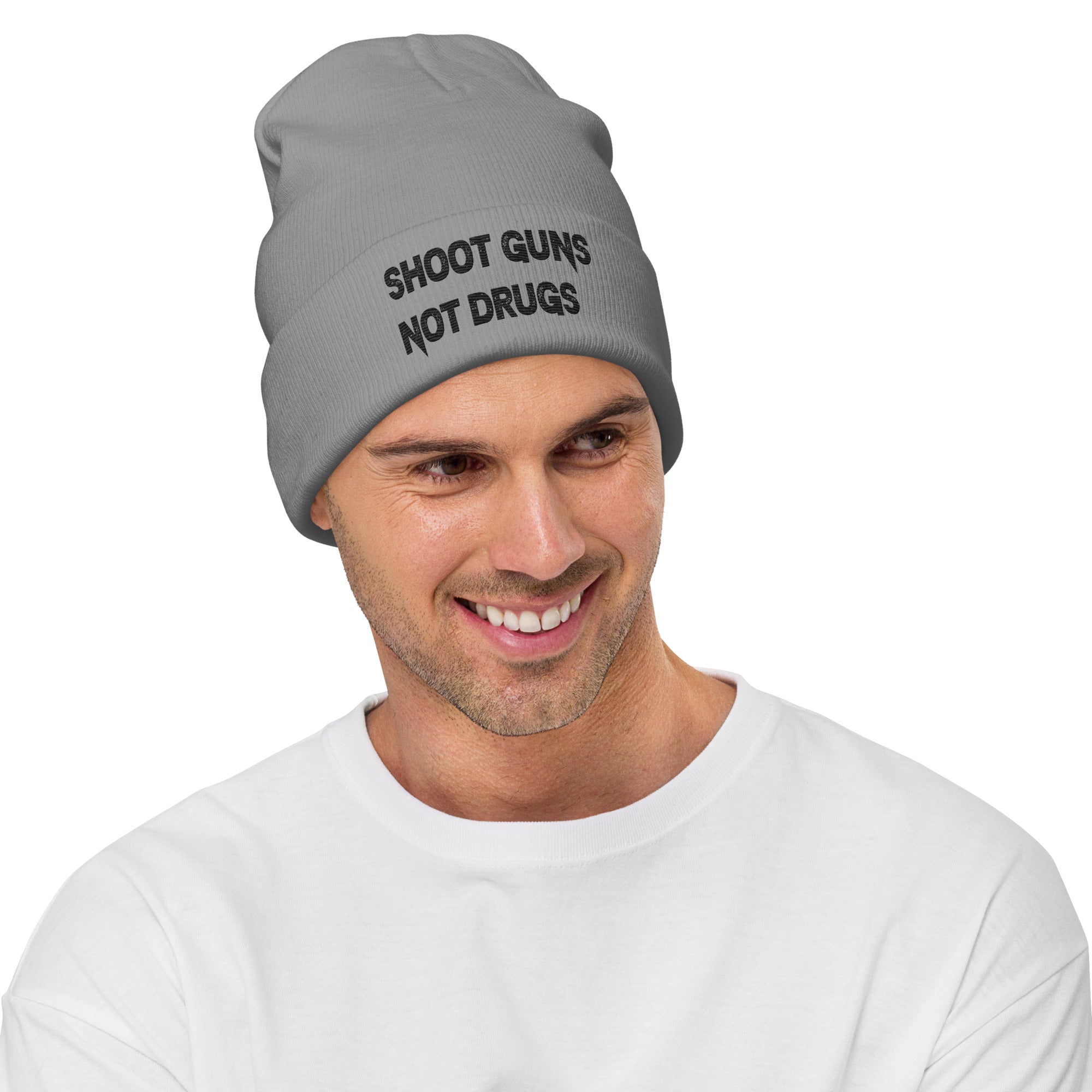 Shoot Guns Not Drugs No Gun - Embroidered Cuffed Beanie worn by a smiling man in a gray hat.